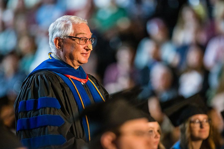 Dr. Mike Wilson stood to be recognized 五月 7 during one of Northwest's commencement ceremonies for the completion of a bachelor’s degree in theatre performance, which he earned after serving the University for 27 years as a faculty member. (Photo by Todd Weddle/<a href='http://mc9.thebigkahunaspokane.com'>和记棋牌娱乐</a>)
